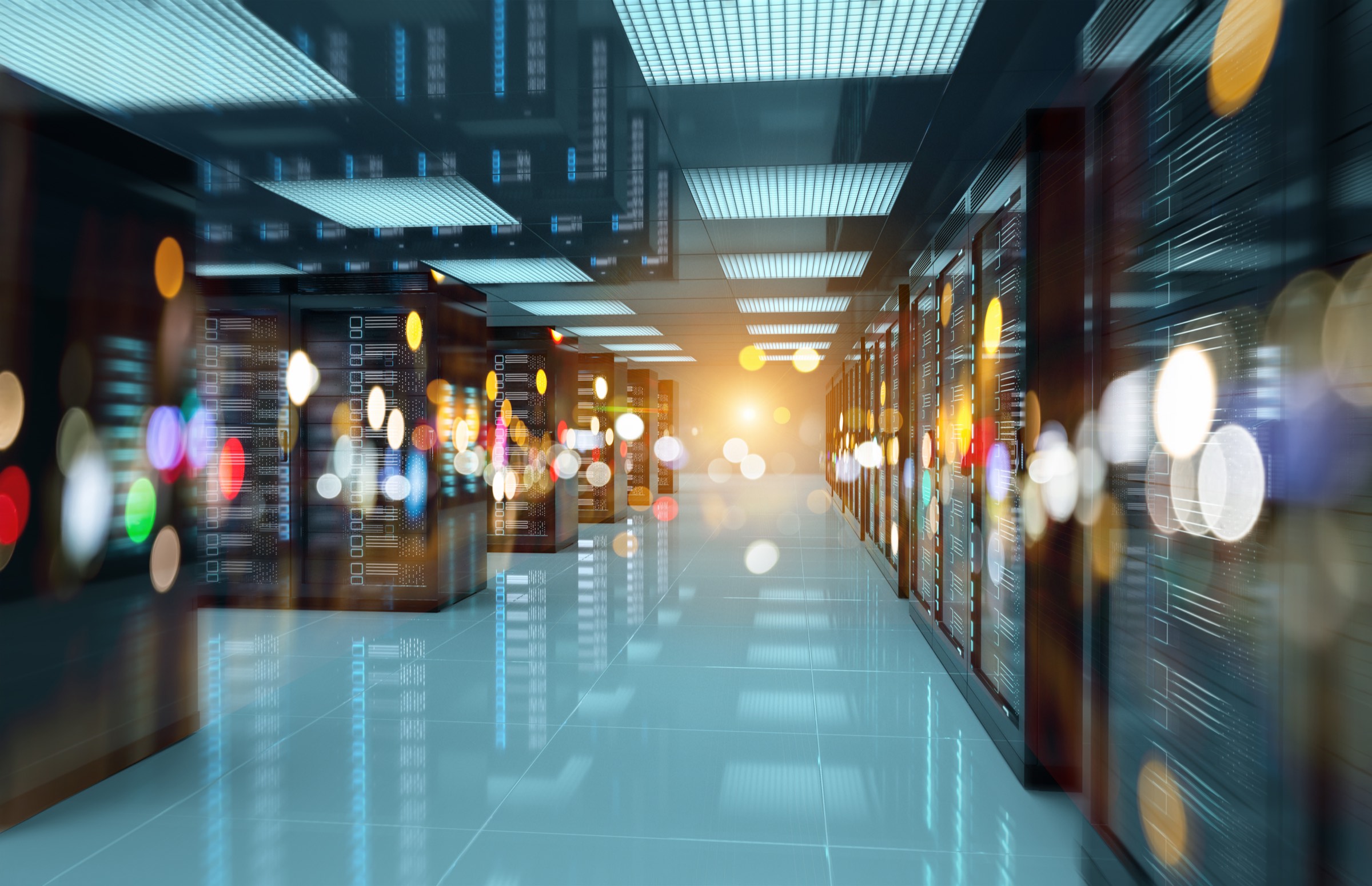 A datacentre aisle, racks receding into light